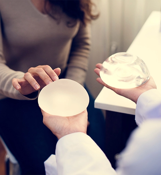 patient choosing from different breast implant options with plastic surgeon