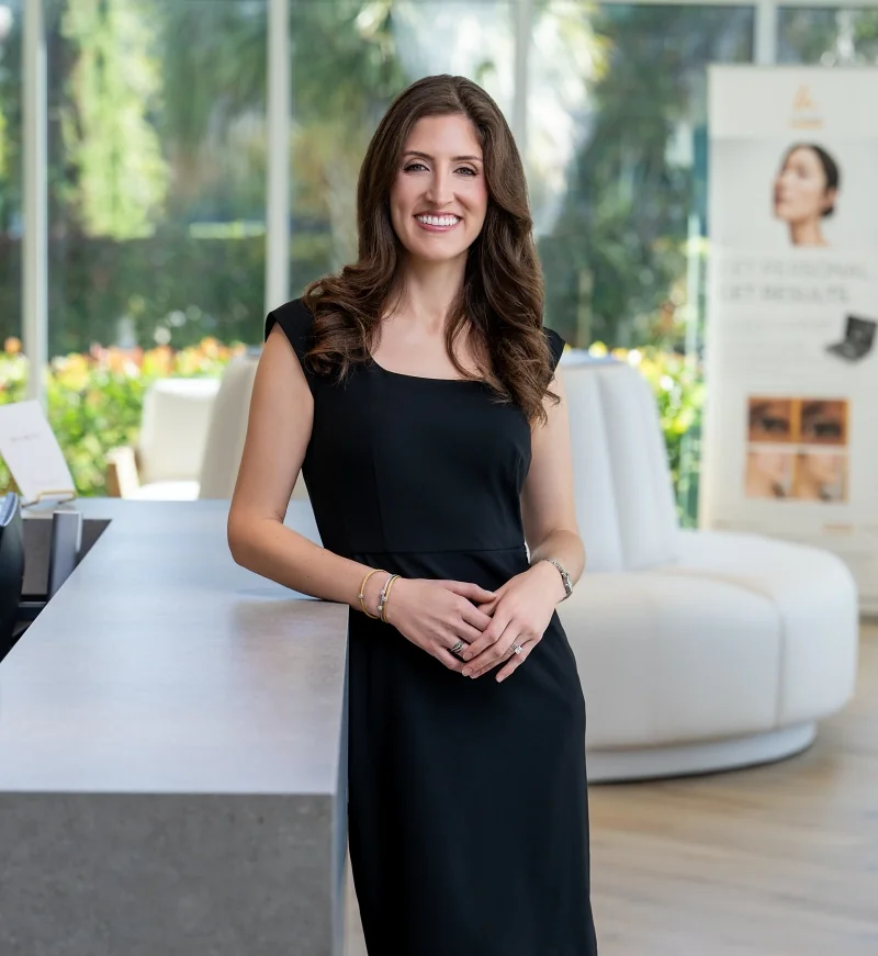 Dr. Anderson smiling and standing in the lobby at Naples Aesthetic Institute