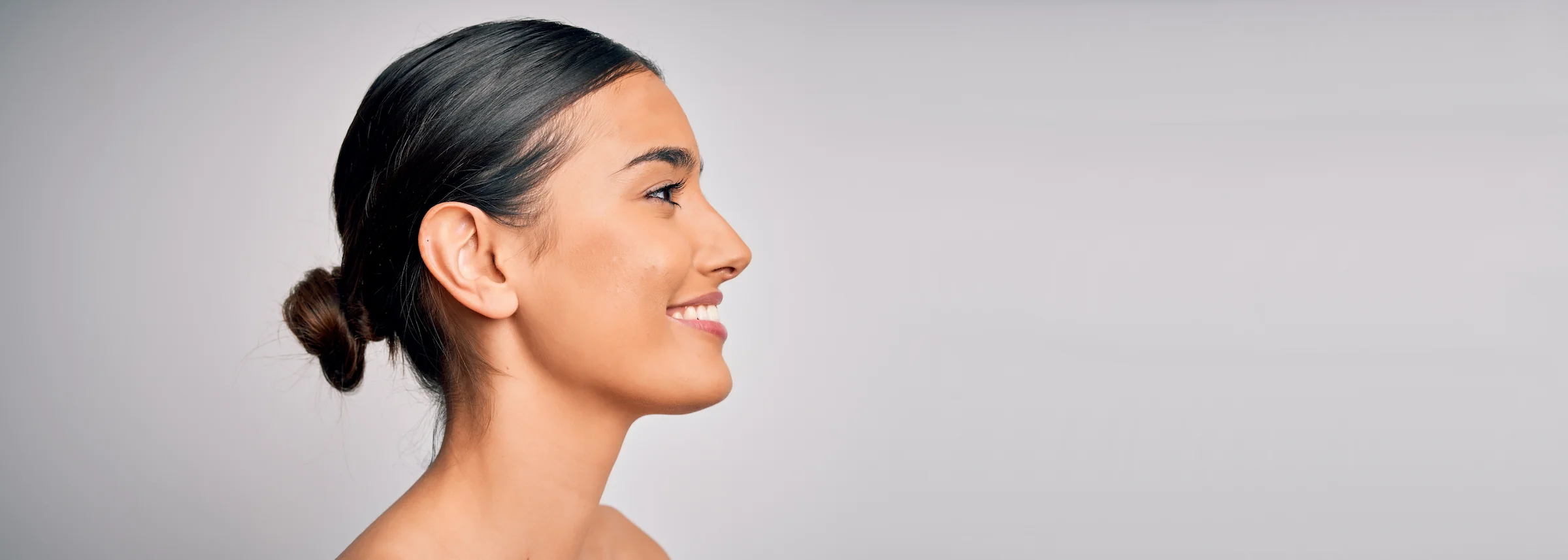 Close up of young beautiful woman with clear and pure skin. Perfect and clean skincare wearing natural makeup